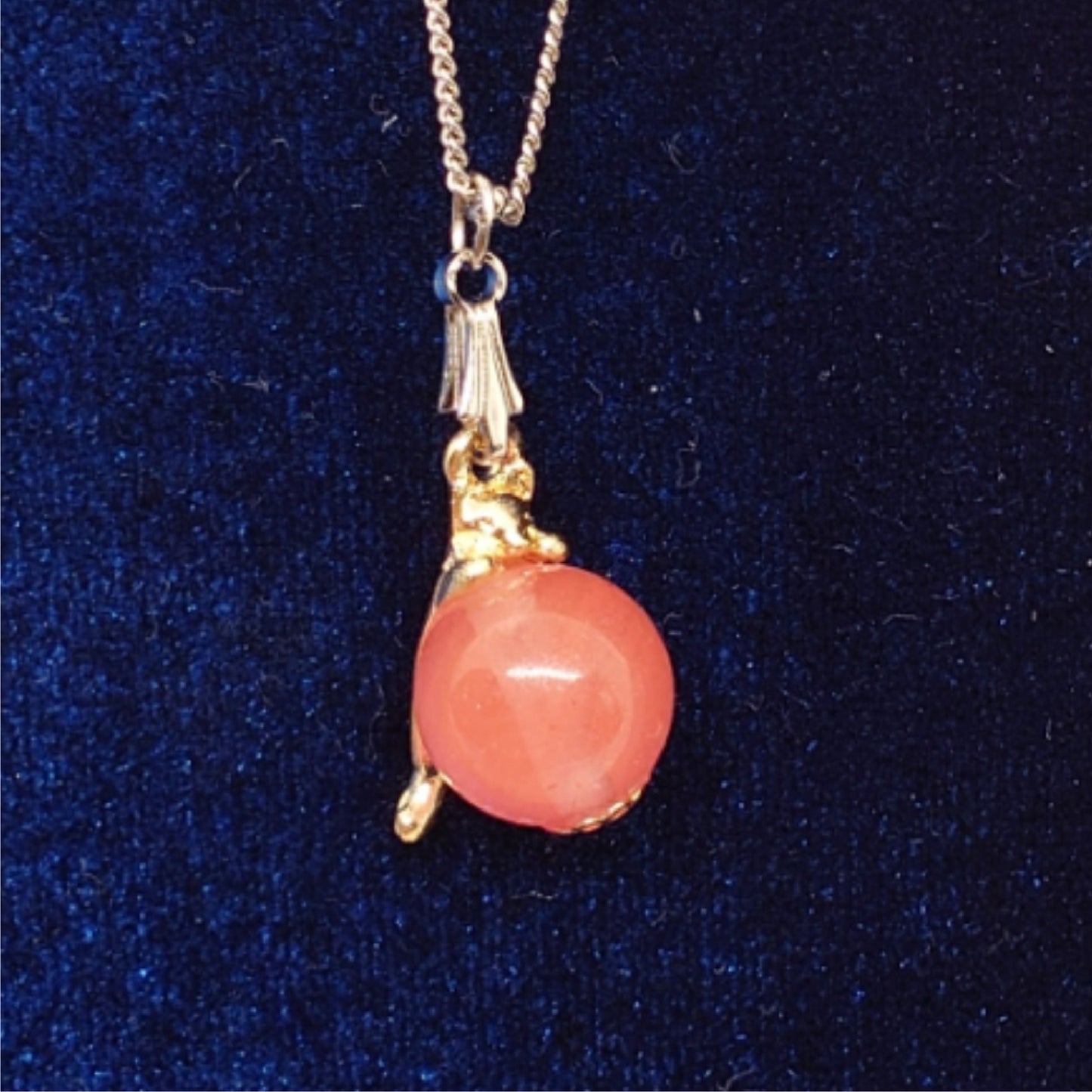 Cat necklace hanging from natural stone